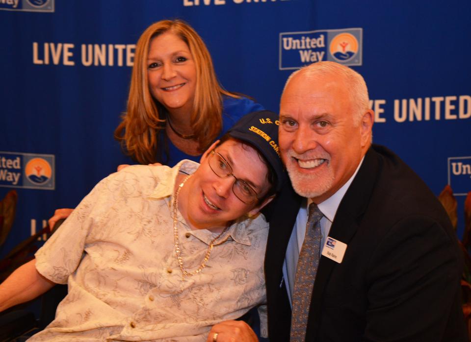 Rob Rains, president of United Way of Brevard, right, and Jackie Barker, left, Sky Advertising and 2022 campaign chair, pose with Alby Powers, who received the Walk of Fame Award during United Way's 2021 campaign celebration at the Hilton Melbourne Rialto Place Tuesday.