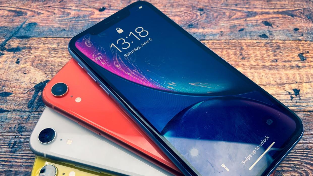 The composition of the iPhone XR front screen display has been used with several color variations, arranged on the table.