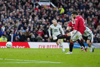 Manchester United's Bruno Fernandes scores his side's opening goal from a penalty kick during the English FA Cup quarterfinal soccer match between Manchester United and Fulham at the Old Trafford stadium in Manchester, England, Sunday, March 19, 2023. (AP Photo/Jon Super)