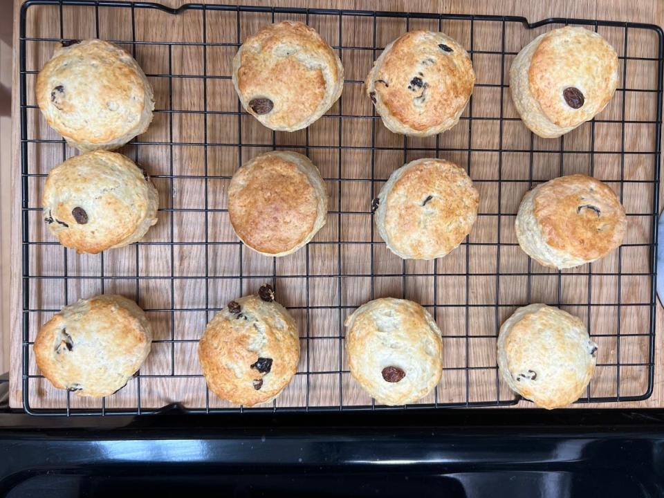 An overhead view of freshly baked scones on a wire cooling rack.