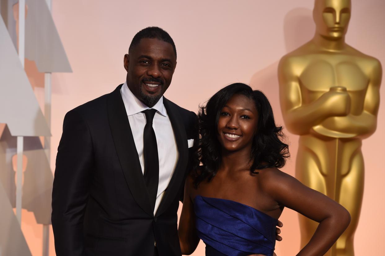 Idris Elba and his daughter, Isan, at the 2015 Oscars. “Issy,” as the actor calls her, has been named the 2019 Golden Globe ambassador. (Photo: Mark Ralston/AFP/Getty Images)