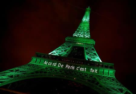 The Eiffel tower is illuminated in green with the words "Paris Agreement is Done", to celebrate the Paris U.N. COP21 Climate Change agreement in Paris, France, November 4, 2016. REUTERS/Jacky Naegelen/Files