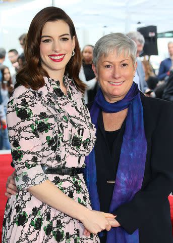 <p>Jean-Baptiste Lacroix/AFP via Getty</p> Anne Hathaway and her mom Kate McCauley Hathaway stand on Hathaway's newly unveilled Star on the Hollywood Walk Of Fame in front of the Chinese theatre on May 09, 2019