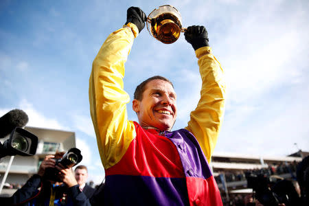 Horse Racing - Cheltenham Festival - Cheltenham Racecourse, Cheltenham, Britain - March 16, 2018 Richard Johnson celebrates with the trophy after riding Native River to victory in the 15.30 Timico Cheltenham Gold Cup Chase Action Images via Reuters/Matthew Childs