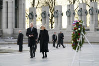 President Joe Biden and first lady Jill Biden walk towards a wreath and mark the 80th anniversary of the Japanese attack on Pearl Harbor with a visit to the World War II Memorial, Tuesday, Dec. 7, 2021, in Washington. (AP Photo/Evan Vucci)