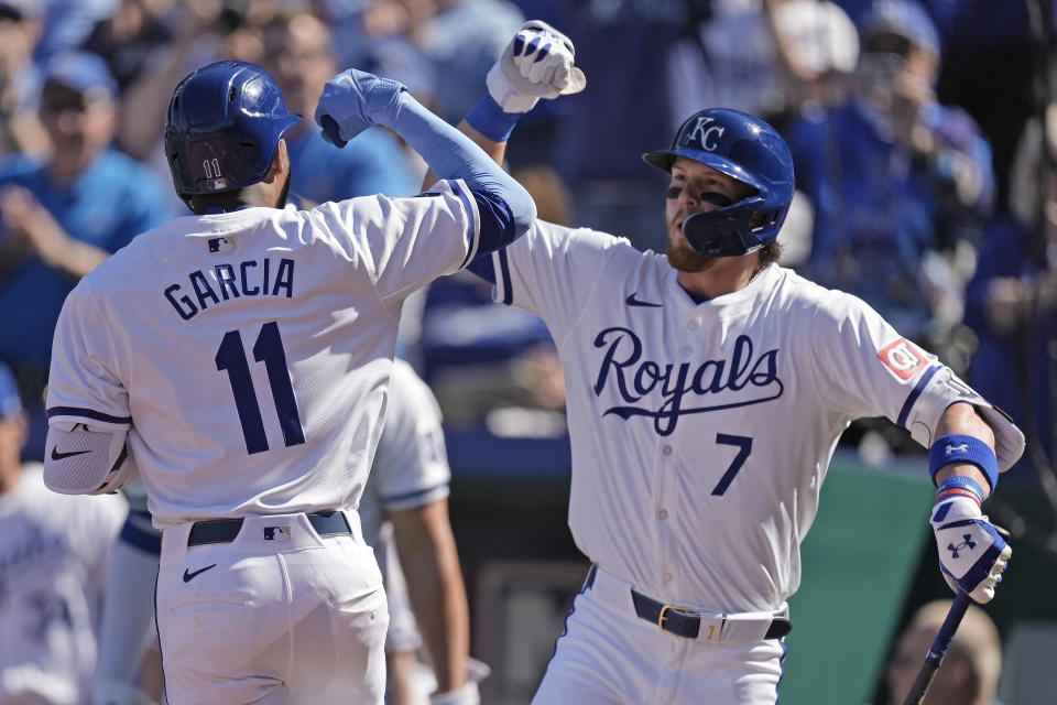 Maikel Garcia celebrates with Bobby Witt Jr. (7) after hitting a solo home run during the first inning of a baseball game against the Minnesota Twins Thursday, March 28, 2024, in Kansas City, Mo. (AP Photo/Charlie Riedel)