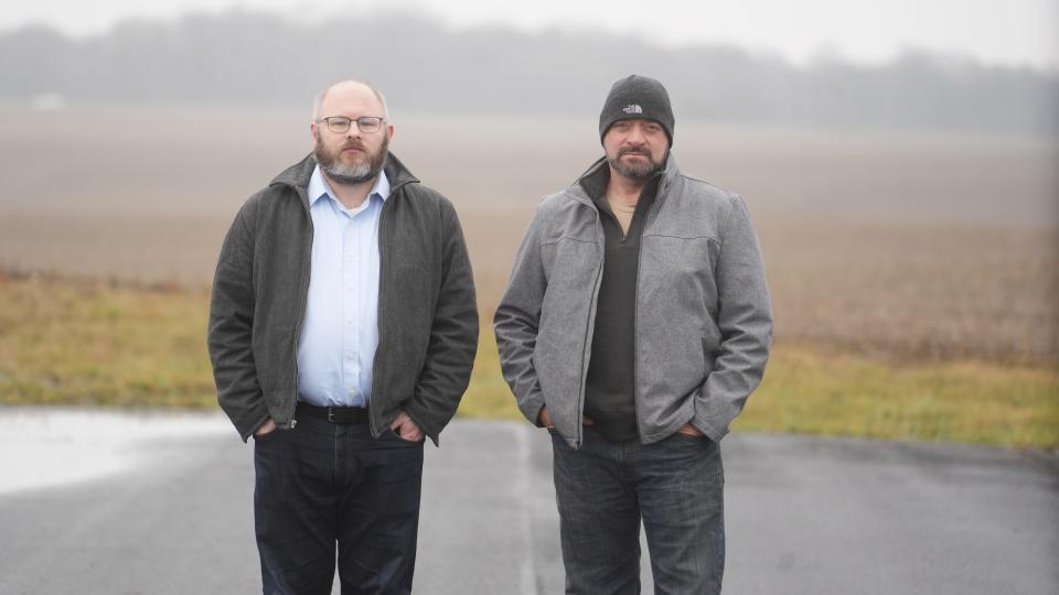 Judd Templin (left) and Kerry Hamilton, homeowners in the Grand Pointe neighborhood, are trying to "vacate" or permanently close about 200 feet of Grand Pointe Drive to stop it from being an access road to a possible development on farmland east of the community.