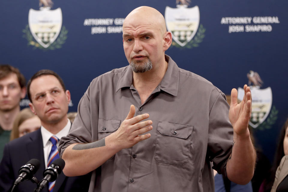 FILE - Pennsylvania Lt. Gov. John Fetterman, right, speaks as he stands beside state Attorney General Josh Shapiro during a news conference about legal action in the dispute between health insurance providers UPMC and Highmark, Feb. 7, 2019, in Pittsburgh. (AP Photo/Keith Srakocic, File)