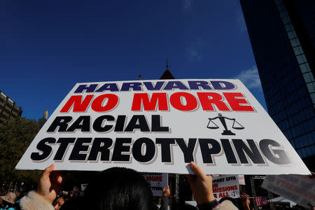 A supporter carrying a "Harvard No More Racial Stereotyping" sign attends the "Rally for the American Dream - Equal Education Rights for All," ahead of the start of the trial in a lawsuit accusing Harvard University of discriminating against Asian-American applicants, in Boston, Massachusetts, U.S., October 14, 2018. REUTERS/Brian Snyder