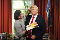 <p>Just like his predecessors, President Donald Trump finally made it into London’s famous Madame Tussaud’s waxworks. This slightly surreal picture shows make-up Chris Gargiuol applying the finishing touches to Trump’s orange visage to coincide with the new Commander-in-Chiefs inauguration. (© DavidJensen/EMPICS Entertainment) </p>