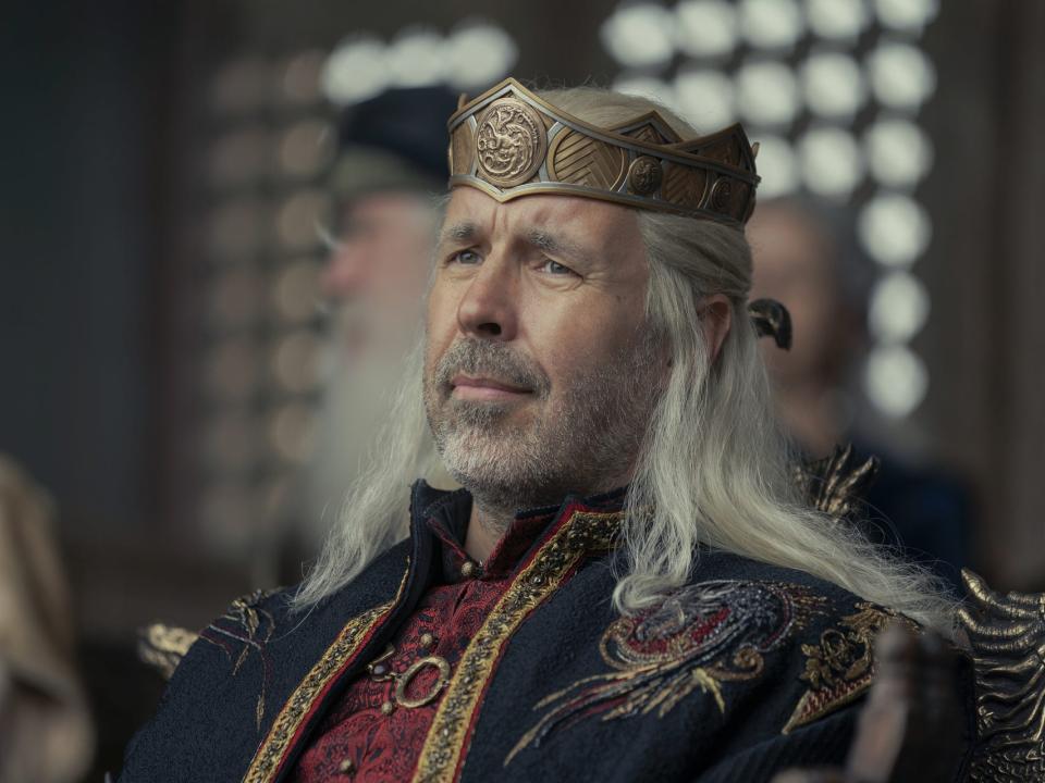 paddy considine as viserys targaryen in house of the dragon. he's a middle aged man with silver blonde hair, grey stubble, and wearing a crown