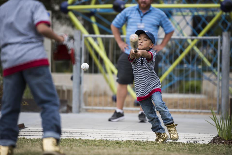 Brothers Augustine-Pio, Alphonsus-Leo and Hyacinth-Michael&nbsp;play baseball at Midtown Park in Houston.