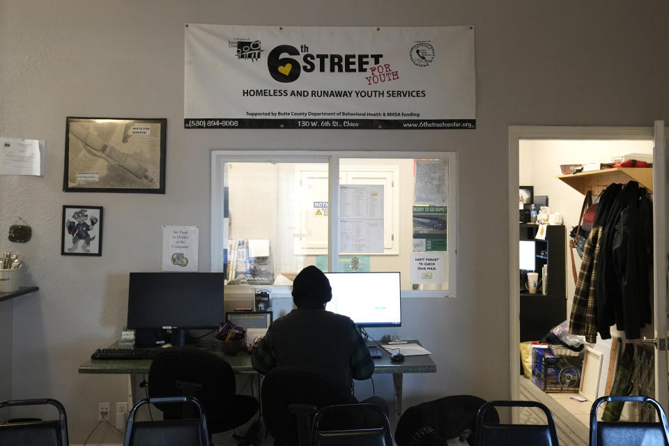 A person works on a computer, one of the many services provided at the 6th Street Center for Youth in Chico, Calif., Feb. 8, 2024. A measure aimed at transforming how California spends money on mental health will go before voters in March as the state continues to grapple an unabated homelessness crisis. Providers say the center is Chico's only drop-in facility for troubled youth that helps provide clothing, meals, and also offers rent assistance to college student Workers at the center do not believe that these services would protect it from funding cuts if Proposition 1 is approved in March. (AP Photo/Rich Pedroncelli)