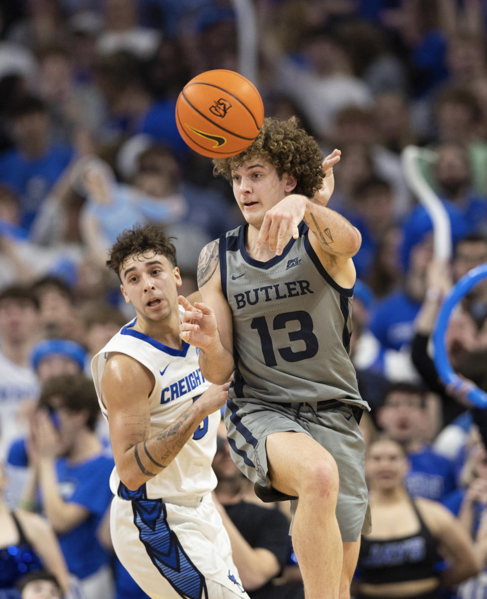 Butler's Finley Bizjack, right, passes the ball against Creighton's Francisco Farabello during the second half of an NCAA college basketball game Friday, Feb. 2, 2024, in Omaha, Neb. Butler defeated Creighton 99-98. (AP Photo/Rebecca S. Gratz)