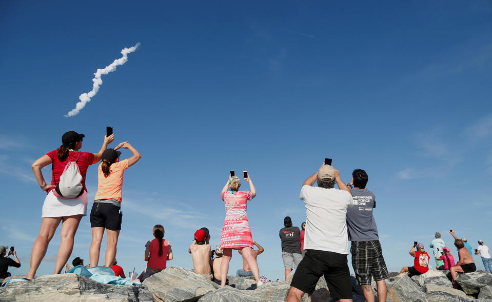 <p>Spectators at Cocoa Beach watch SpaceX’s first Falcon Heavy rocket launch from the Kennedy Space Center, Fla., Feb, 6, 2018. (Photo: Gregg Newton/Reuters) </p>