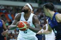 Aug 14, 2016; Rio de Janeiro, Brazil; United States center Demarcus Cousins (12) prepares to shoot the ball in front of France guard Thomas Heurtel (4) during the men's preliminary round in the Rio 2016 Summer Olympic Games at Carioca Arena 1. Jeff Swinger-USA TODAY Sports