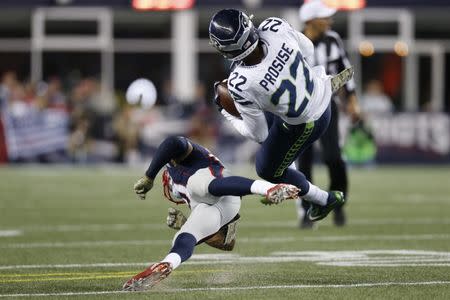 Nov 13, 2016; Foxborough, MA, USA; Seattle Seahawks running back C.J. Prosise (22) is up ended by New England Patriots cornerback Malcolm Butler (21) during the fourth quarter at Gillette Stadium. The Seattle Seahawks won 31-24. Mandatory Credit: Greg M. Cooper-USA TODAY Sports