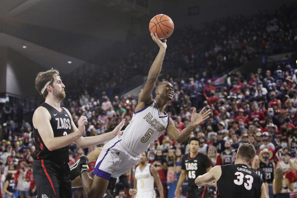 Alcorn State guard Keondre Montgomery, center, shoots between Gonzaga forwards Drew Timme, left, and Ben Gregg during the first half of an NCAA college basketball game, Monday, Nov. 15, 2021, in Spokane, Wash. (AP Photo/Young Kwak)