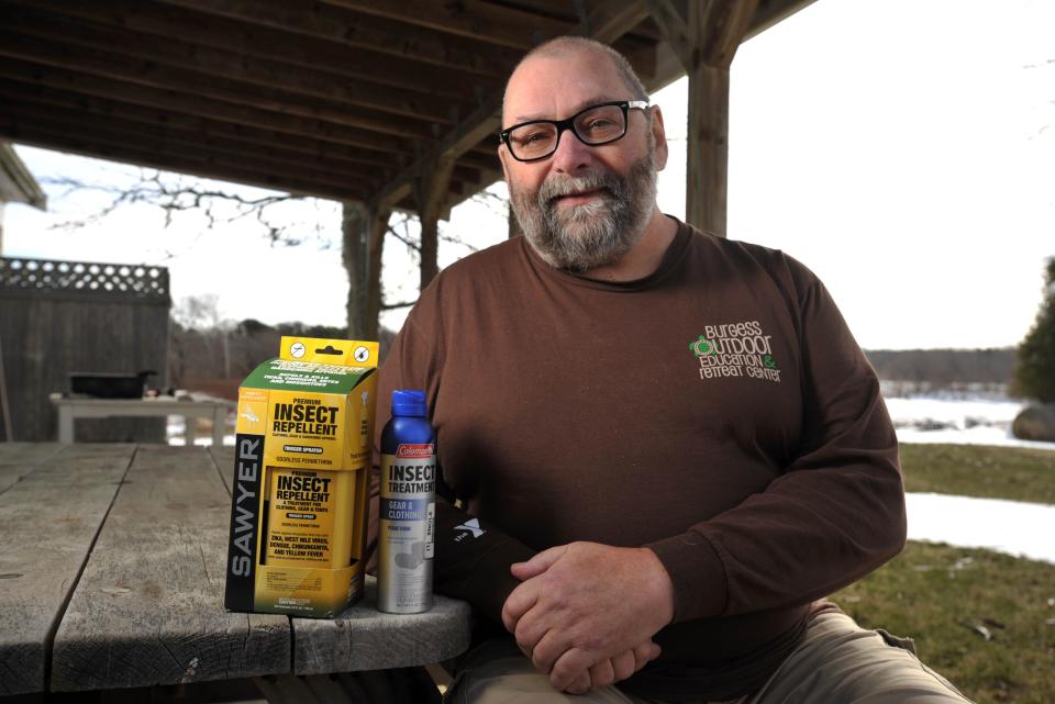 Barnstable County entomologist Larry Dapsis, with the Cape Cod Cooperative Extension, says if ever there was a force that could build unanimous consensus on the Cape, it's ticks.  "Everybody hates ticks," he said. Dapsis, in a 2018 photo, sits next to products designed to protect homeowners and their lawns from ticks.