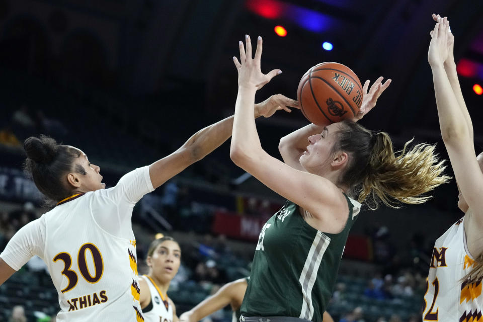 Iona center Ketsia Athias (30) blocks a shot by Manhattan forward Petra Juric during the first half of an NCAA college basketball game in the championship of the Metro Atlantic Athletic Conference Tournament, Saturday, March 11, 2023, in Atlantic City N.J. (AP Photo/Matt Rourke)