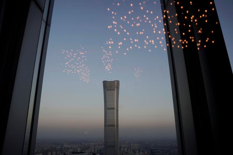 FILE PHOTO: China Zun Tower under construction is seen through a window in Beijing's central business area