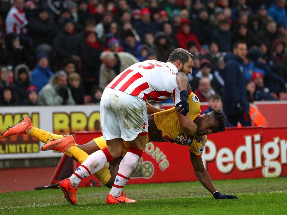 Wilfried Zaha and Erik Pieters tussle as they fall to the ground (Getty)