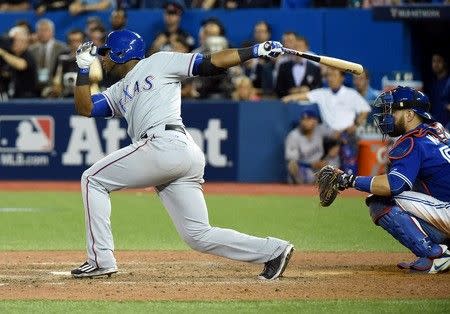 Oct 9, 2015; Toronto, Ontario, CAN; Texas Rangers infielder Hanser Alberto hits an RBI single against the Toronto Blue Jays in the 14th inning in game two of the ALDS at Rogers Centre. Mandatory Credit: Dan Hamilton-USA TODAY Sports