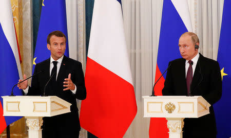 Russian President Vladimir Putin (R) and his French counterpart Emmanuel Macron attend a news conference after the talks in St. Petersburg, Russia May 24, 2018. REUTERS/Grigory Dukor