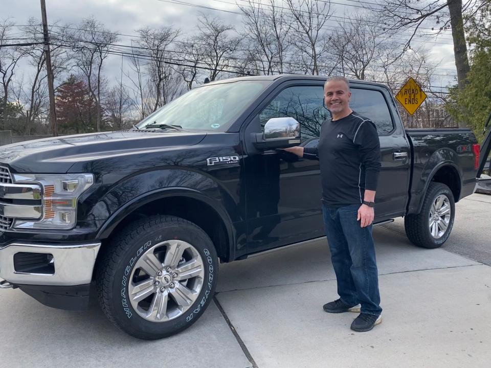 Mohamad "Catfish" Baidoun is a longtime Ford car salesman whose dealership is closed due to the novel coronavirus. He is pictured here  with his 2020 Ford F-150 in his front yard in Dearborn Heights on April 1, 2020.