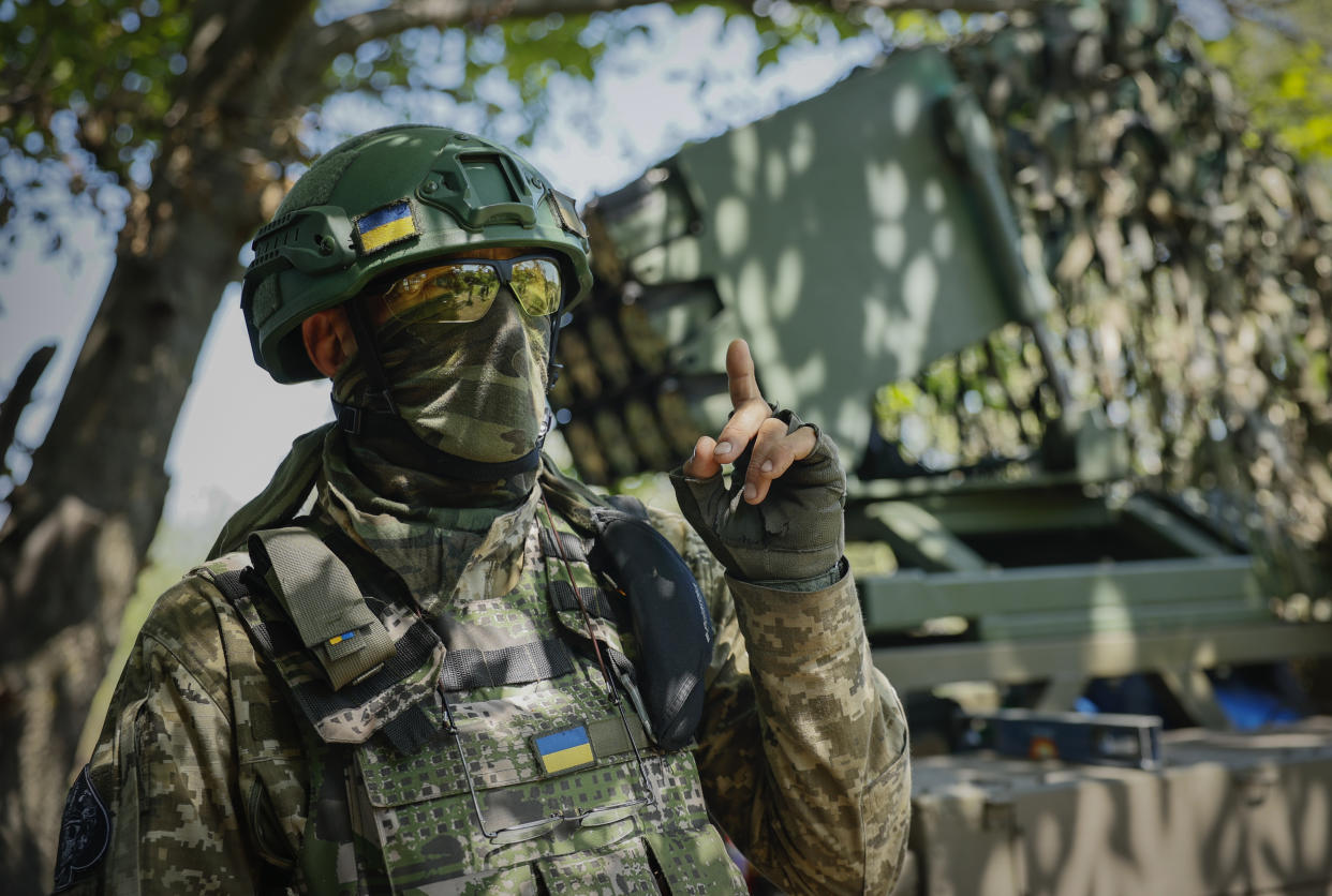 A Ukrainian soldier gestures as he prepares a Croatian RAK-SA-12 128mm multiple rocket launcher to fire towards the Russian positions on the frontline near Bakhmut in the Donetsk region, Ukraine. 