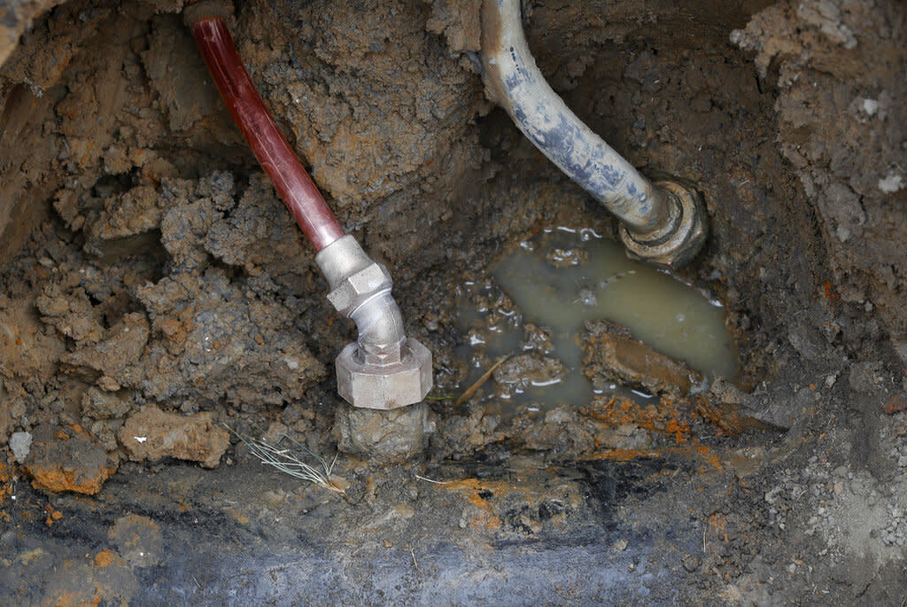Toxic lead pipe next to a copper pipe underground