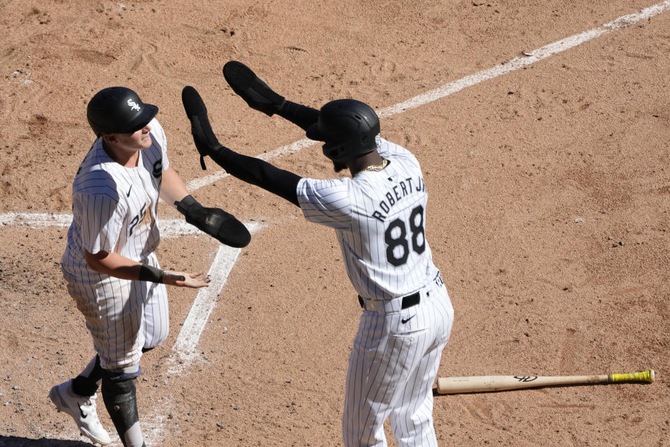 Chicago White Sox's Andrew Vaughn, left, and Luis Robert Jr. celebrate after scoring on Lenyn Sosa's two-run double off Los Angeles Angels starting pitcher Tyler Anderson during the fifth inning of a baseball game Thursday, Sept. 26, 2024, in Chicago. (AP Photo/Charles Rex Arbogast)