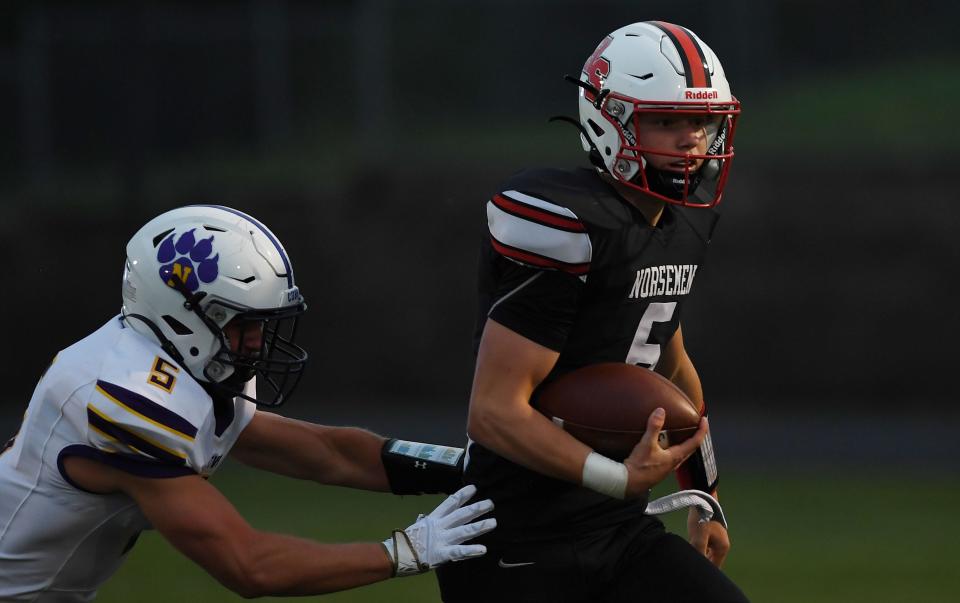 Roland-Story quarterback Hesston Johnson (5) runs by Nevada linebacker Anthony Eaton (5) for a first down during the first quarter at Kerry Van Winkle Field Friday, Sept. 9, 2022, in Story City, Iowa.