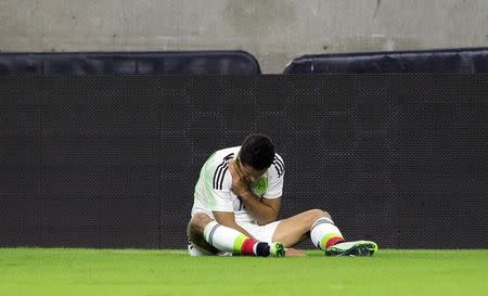 Jul 1, 2015; Houston, TX, USA; Mexico forward Javier Hernandez (14) collides with Honduras defender Brayan Beckeles (not pictured) and injures himself during the first half at NRG Stadium. Mandatory Credit: Kevin Jairaj-USA TODAY Sports