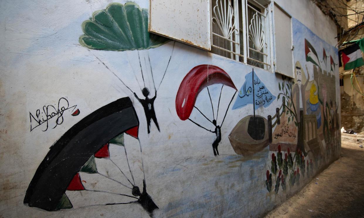 <span>A mural reminiscent of Hamas militants descending into Israel on the walls of the Burj al-Barajneh refugee camp, by Nihaya Ayman Ibrahim.</span><span>Photograph: Lina Malers</span>