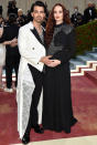 The couple turned heads at the Met Gala wearing color-coordinated Louis Vuitton outfits. Turner showed off her growing belly amid her second pregnancy in a black maxi gown, while her husband wore a white tuxedo-style jacket with dramatic tails.