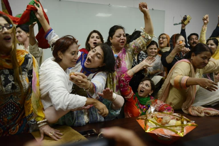 Opposition supporters celebrate the ousting of Prime Minister Nawaz Sharif