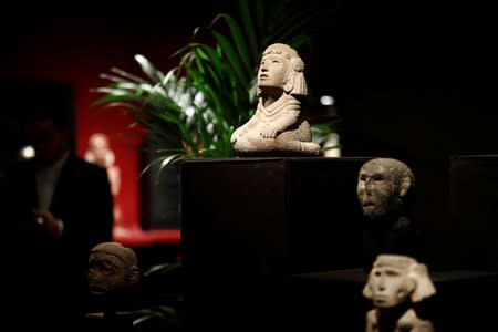 A stone kneeling figure of Aztec water goddess Chalchiuhtlicue, one of pre-Columbian artefacts, is presented to the press at Drouot auction house in Paris