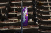 A flag hangs from a building under construction in Lusail downtown, Qatar, Thursday, Nov. 24, 2022. (AP Photo/Pavel Golovkin)