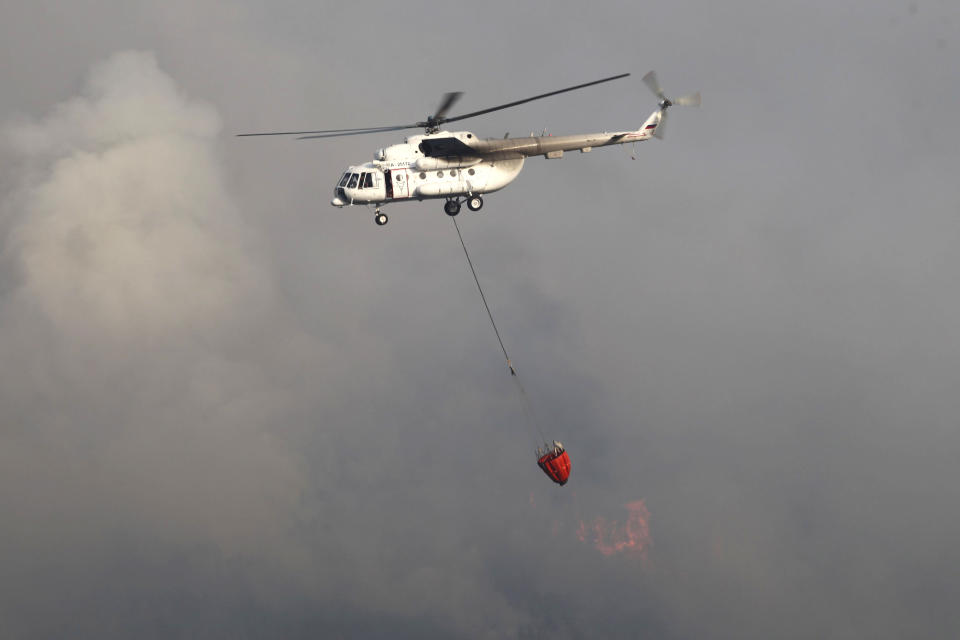 A water-dropping aircraft flies over the Bordubet region, near Marmaris, western Turkey, Thursday, June 23, 2022. Water-dropping aircraft from Azerbaijan and Qatar on Friday joined the fight against a wind-stoked wildfire that burned for a fourth day near a popular resort in southwestern Turkey. Turkey's forestry minister meanwhile, said the fire may be close to being contained but said the wind still posed a risk. (AP Photo)