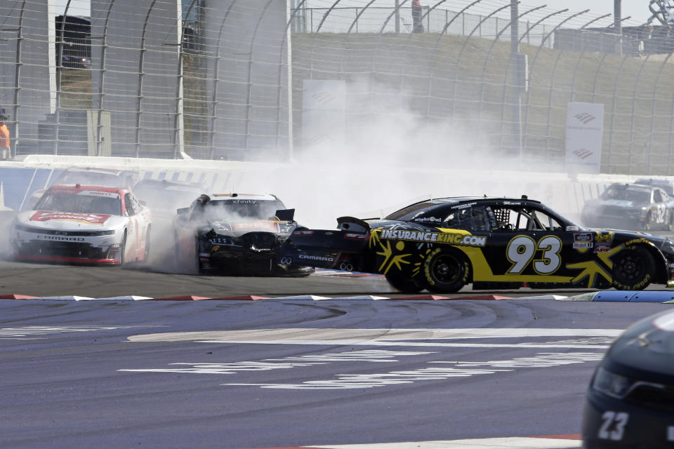 Josh Bilicki (93) spins in front of JJ Yeley and Michael Annett, left, in Turn 11 during the the NASCAR Xfinity Series auto race at Charlotte Motor Speedway in Concord, N.C., Saturday, Sept. 28, 2019. (AP Photo/Wesley Broome)