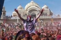 Revelers covered in colored corn starch celebrate during the 2014 Festival of Colors, Holi Celebration at the Krishna Temple Saturday, March 29, 2014, in Spanish Fork, Utah. Nearly 70,000 people are expected to gather starting Saturday at a Sri Sri Radha Krishna Temple in Spanish Fork for the annual two-day festival of colors. Revelers gyrate to music and partake in yoga during the all-day festival, throwing colored corn starch in the air once every hour. The Salt Lake Tribune reports that the large majority of participants are not Hindus, but Mormons. Thousands of students from nearby Brigham Young University come to take part in a festival that is drug and alcohol free. The event stems from a Hindu tradition celebrating the end of winter and the triumph of good over evil. (AP Photo/Rick Bowmer)