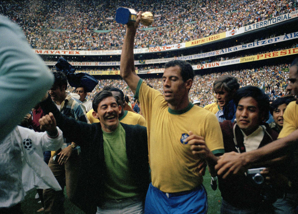 FILE - Captain Carlos Alberto, center, of Brazil, holds the gold Jules Rimet trophy after his team defeated Italy in the World Cup final soccer match at Azteca Stadium, in Mexico City, June 21, 1970. Brazil won, 4-1. (AP Photo/Gianni Foggia, File)