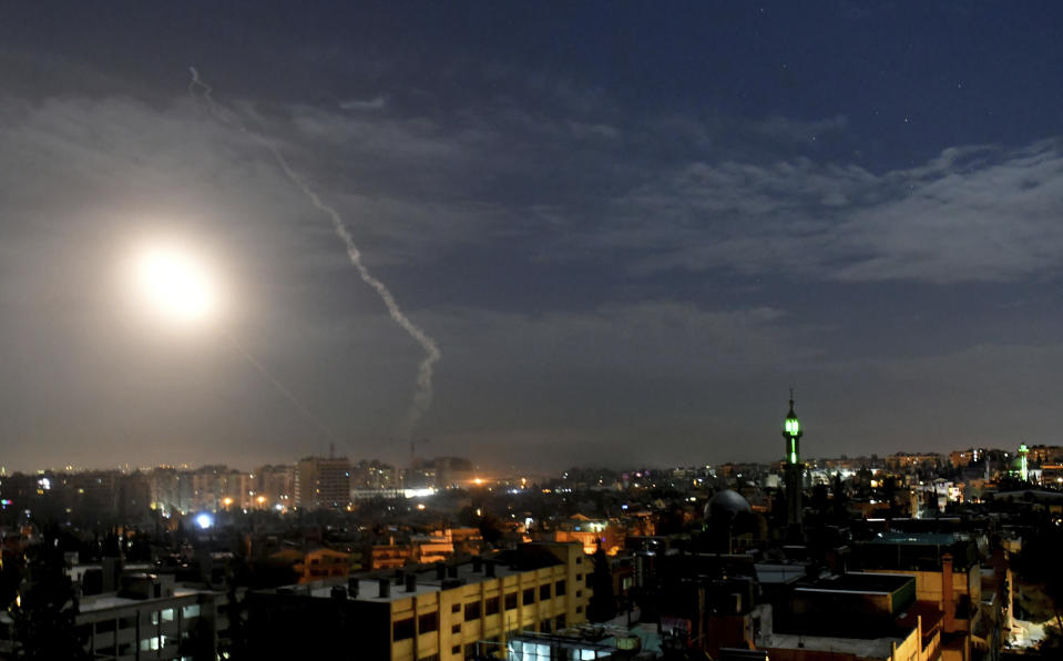 This photo released by the Syrian official news agency SANA, shows missiles flying into the sky near international airport, in Damascus, Syria, Monday, Jan. 21, 2019. In a very unusual move, the Israeli military has issued a statement saying it is attacking Iranian military targets in Syria. It is also warning Syrian authorities not to retaliate against Israel. (SANA via AP)