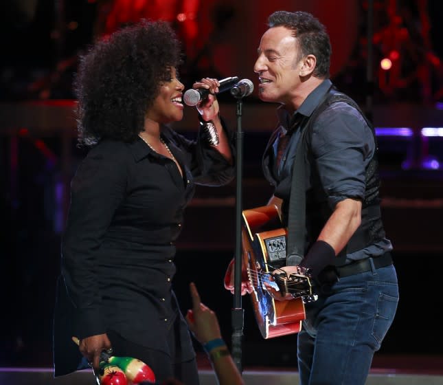 VANCOUVER, CANADA - NOVEMBER 26: Bruce Springsteen (R) performs with Cindy Mizelle at Rogers Arena.
