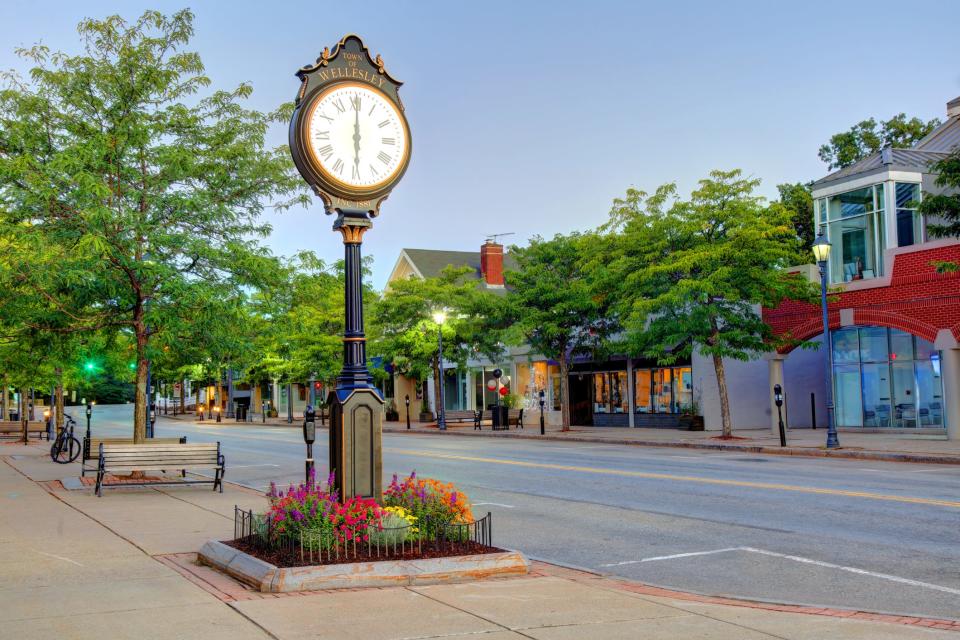 A standing clock on the side of a small town road.