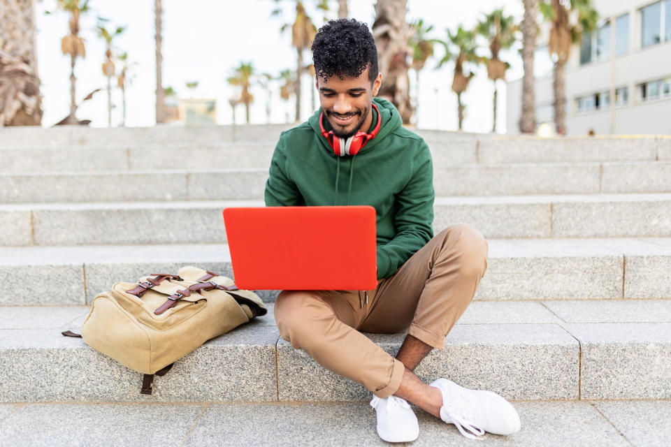 A person typing on their laptop