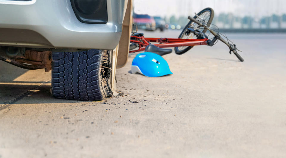 A bicycle on the ground smashed by a vehicle