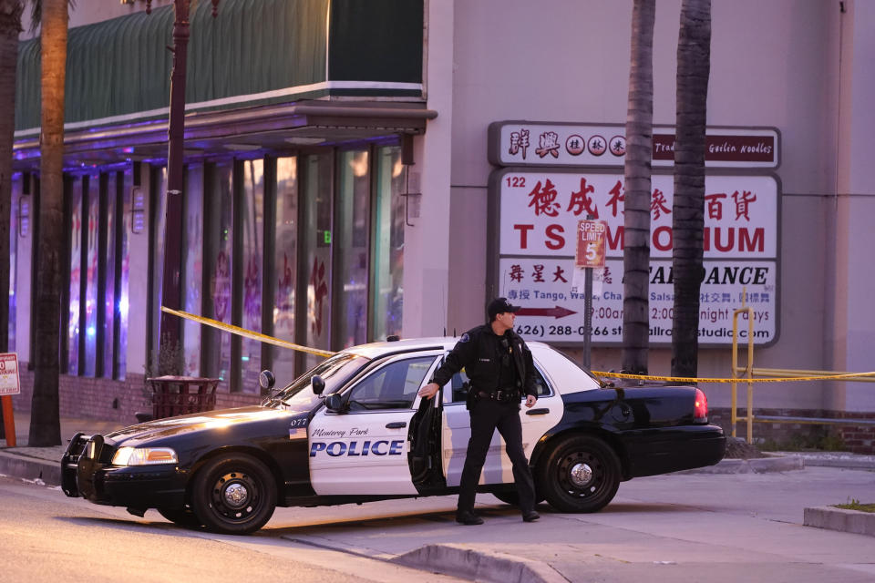 A police officer gets out of his vehicle near a ballroom dance club in Monterey Park, Calif., Sunday, Jan. 22, 2023. A mass shooting took place at a dance club following a Lunar New Year celebration, setting off a manhunt for the suspect. (AP Photo/Jae C. Hong)