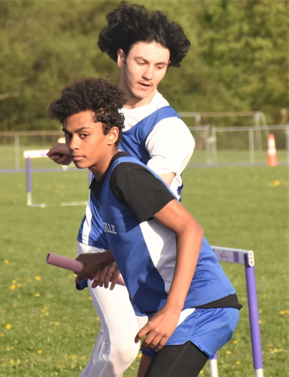 Derek Barnes and Timothy Gomez pass the baton for Dolgeville during the four-by-400-meter relay against the Utica Academy of Science Monday at the West Canada Valley track.